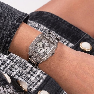 Relógio de pulso prateado com bracelete brilhante e mostrador com sub-mostradores num pulso