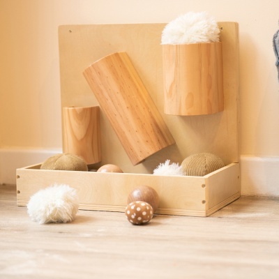 Brinquedos sensoriais de madeira natural com bolas macias e polidas em fundo claro