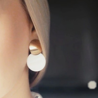 Brinco moderno dourado fosco e branco em mulher