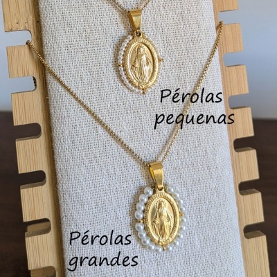 dois colares dourados com pingentes ovais e pérolas em suporte de tecido bege