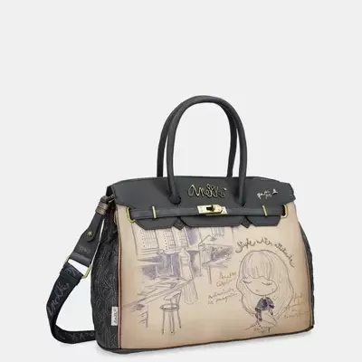 Mala bege e preta com ilustrações e fecho dourado