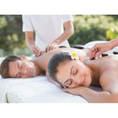 Casal a fazer massagem de pedras quentes ao ar livre