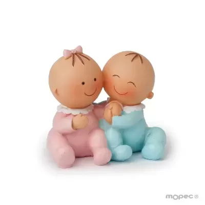 Bonecos de bebés em cerâmica, um de rosa e outro de azul, sorridentes