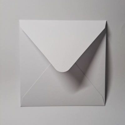 Envelope branco fechado sobre fundo branco com sombra suave