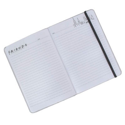 Caderno aberto branco com texto F.R.I.E.N.D.S e desenhos de edifícios na parte superior direita