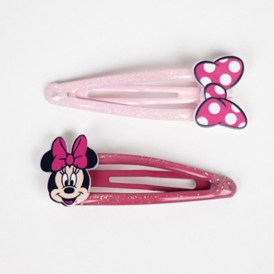 Dois ganchos de cabelo cor-de-rosa com a figura da Minnie e um laço às bolinhas