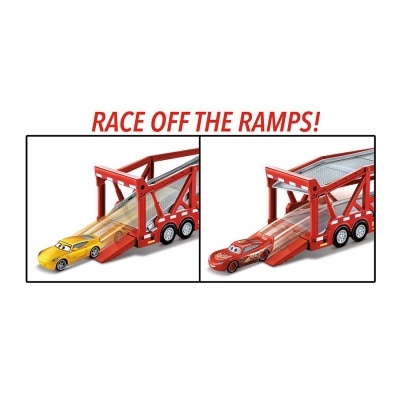 Carrinhas de brinquedo vermelha e amarela num camião reboque vermelho com rampa, texto RACE OFF THE RAMPS!