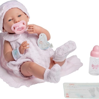 Boneca bebé realista com roupa rosa e acessórios, biberão e cartão de identificação.