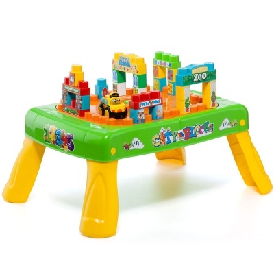 Mesa de jogo infantil verde com blocos de construção coloridos e pernas amarelas.