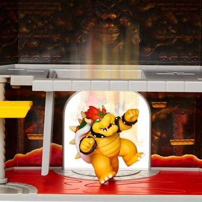 Figura de ação de Bowser em plataforma de jogo com fundo de caverna