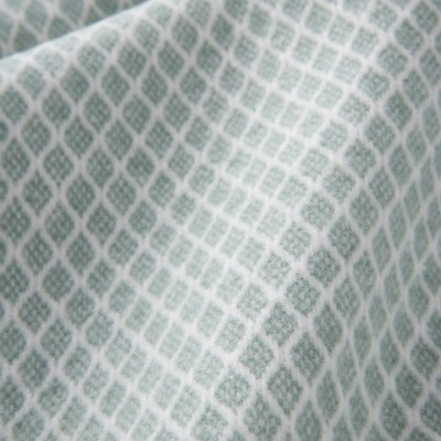 tecido verde e branco com padrão geométrico de losangos