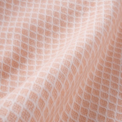 Tecido padrão losangos laranja e branco com textura macia