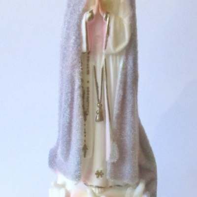 Estátua da Nossa Senhora de Fátima com manto cinza, coroa dourada e base com etiqueta FATIMA