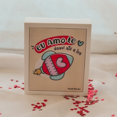 Caixa com ilustração de foguetinho e texto em português com corações vermelhos