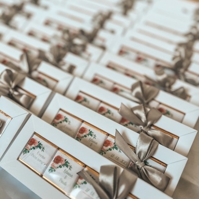 Caixas de presente com chocolates decorados e fita cinzenta