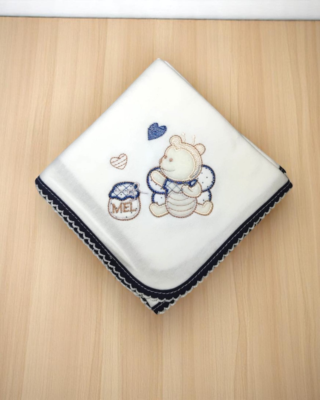 Toalha de bebé branca com bordado de abelha e pote de mel