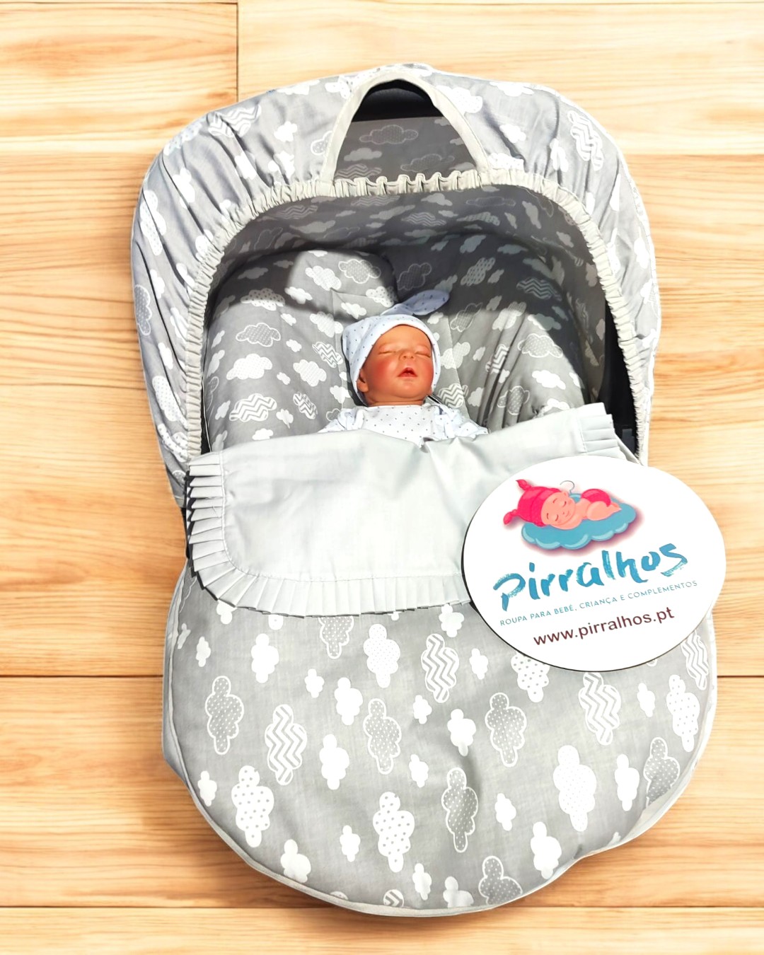 Bolsa-cama para bebé cinzenta com padrão de nuvens e boneco de bebé azul