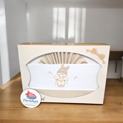 Conjunto de bebé com ursinho bordado em caixa decorativa bege e branca.