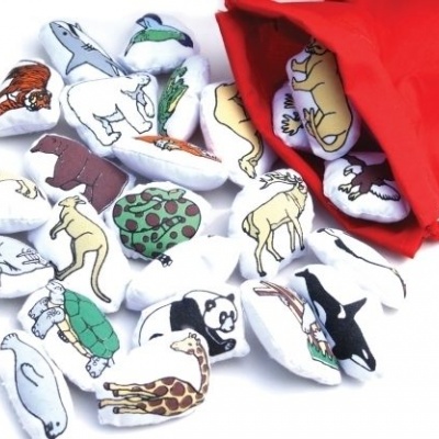 Peças de tecido em forma de animais coloridos ao lado de saco vermelho aberto