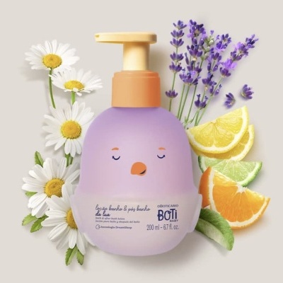 Frasco lilás com tampa laranja e rosto desenhado, rodeado por flores e frutas cítricas