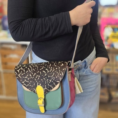 Mala de ombro colorida em couro com padrão e fivela amarela.