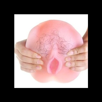 Produto em silicone cor de pele com textura que imita pêlos, representando a região genital feminina