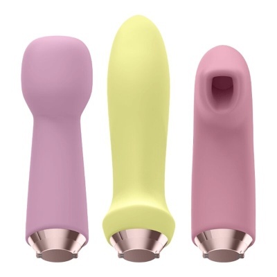 Três dispositivos eletrónicos em silicone rosa claro, amarelo e rosa escuro com bases metálicas.