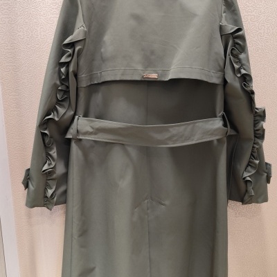 Gabardina cinzento-esverdeado com folhos nas mangas vista de costas