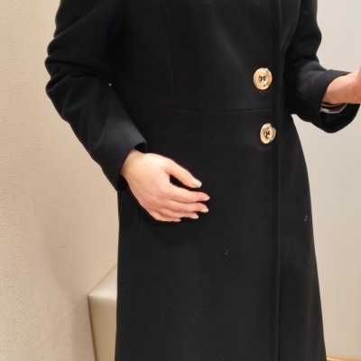 Casaco comprido preto com botões dourados e gola subída