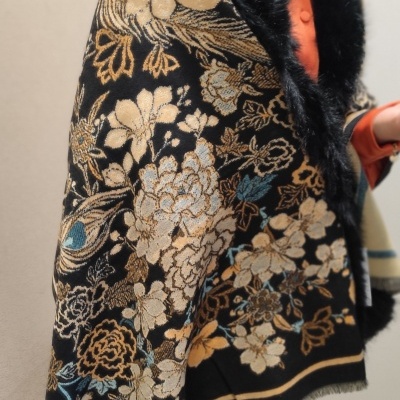 Xale floral preto com pêlo e franjas usado por pessoa