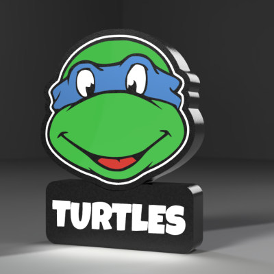 Placa tridimensional da cara de uma tartaruga azul e verde com a palavra TURTLES.