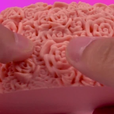 Caixa decorativa cor-de-rosa em forma de coração com bombons Ferrero Rocher no interior.