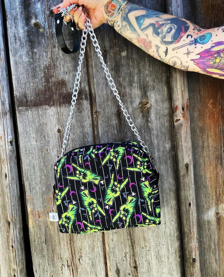 Mala pequena colorida com padrão de folhas e alça de corrente prateada