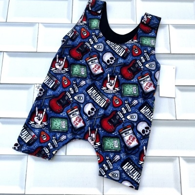 Macacão curto para bebé com padrão colorido de guitarras e caveiras