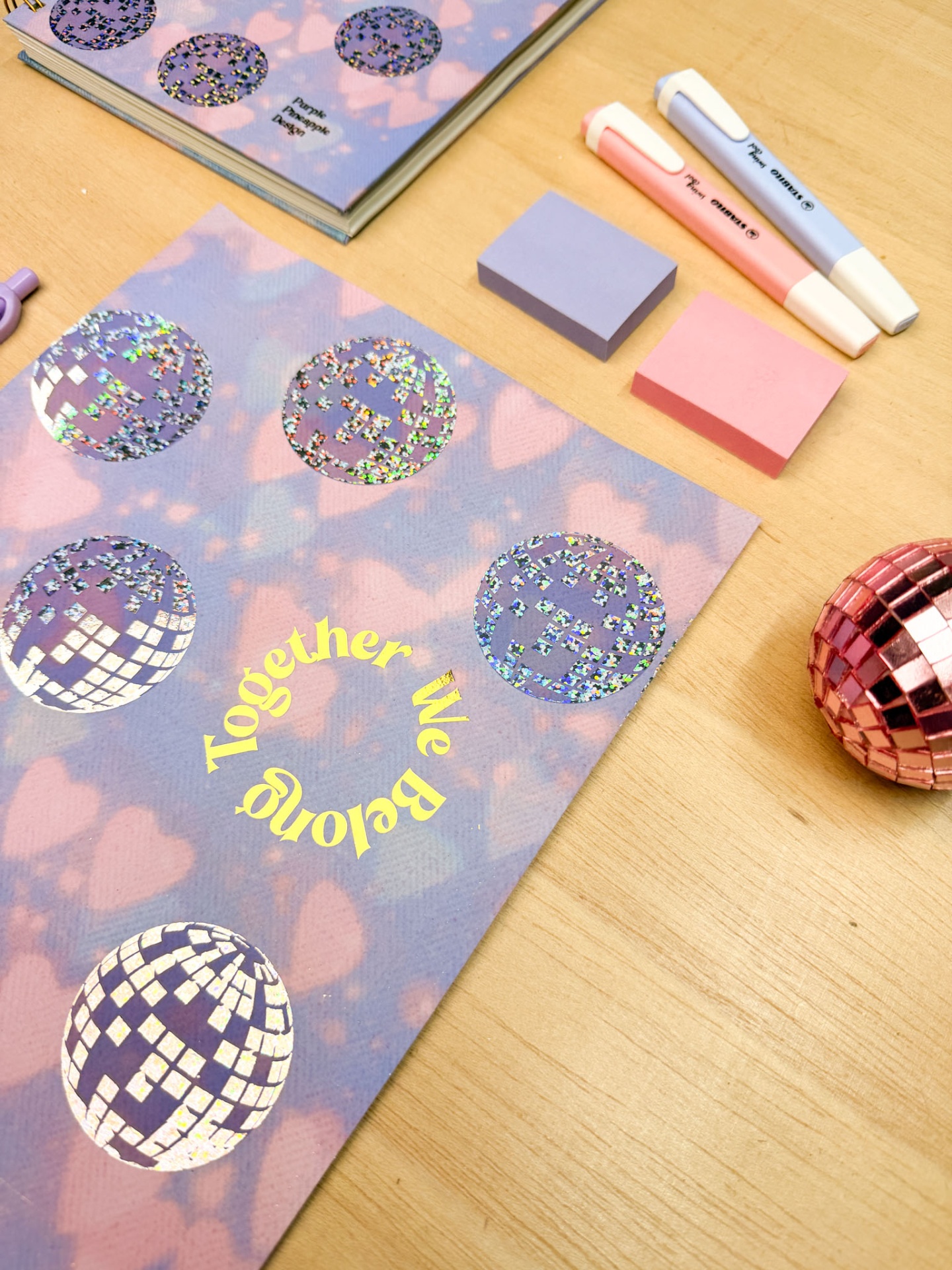 Artigos de papelaria coloridos sobre mesa de madeira clara