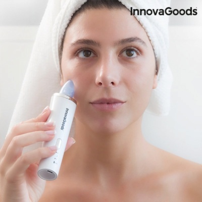 Mulher com toalha na cabeça segurando dispositivo InnovaGoods branco com ponta azul