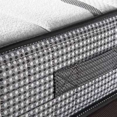 Colchão cinza com padrão às bolinhas e parte superior branca texturizada