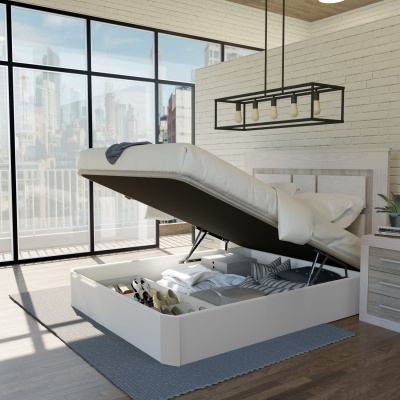 Cama de casal branca estofada com espaço de arrumação aberto, num quarto moderno com janela grande e parede branca em tijolo