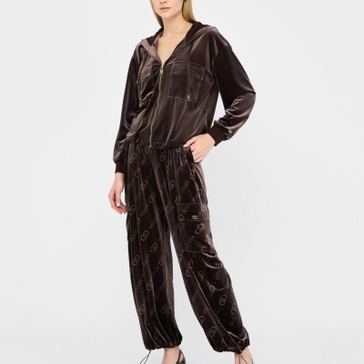 Conjunto de veludo castanho escuro com casaco e calças largas e sapatos pretos de salto