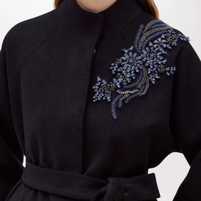 Casaco preto com aplicação decorativa azul no ombro