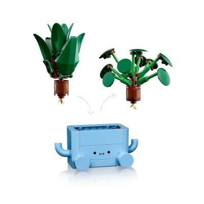 Conjunto de brinquedo de construção com base azul e peças de plantas verdes e castanhas.