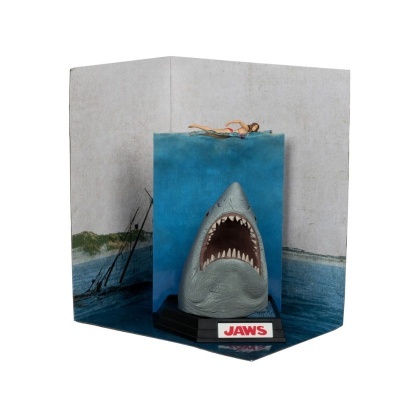 Miniatura de tubarão com boca aberta em pedestal preto com etiqueta JAWS em letras vermelhas