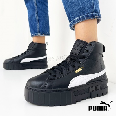 Botas desportivas pretas e brancas Puma de cano alto com sola grossa