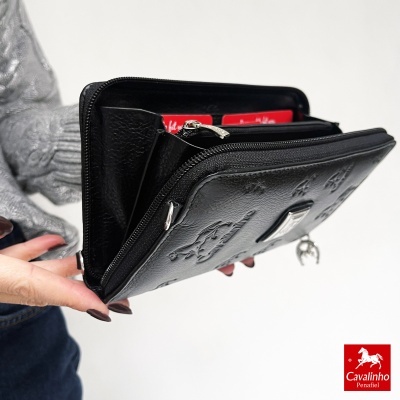 Carteira preta com relevo e fecho de correr na mão