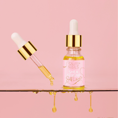 Frasco de sérum transparente com conta-gotas e fundo rosa