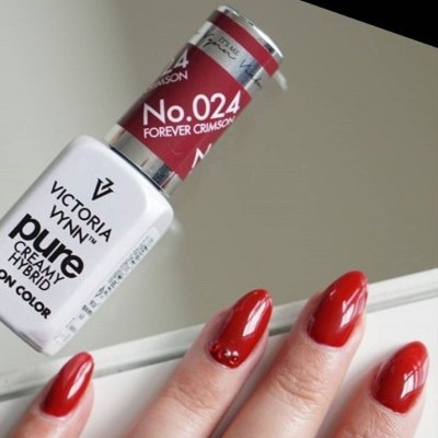 Verniz de unhas Victoria Vynn Pure Creamy Hybrid Color No. 024 junto de unhas pintadas de vermelho brilhante com pedras