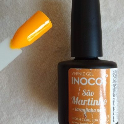 Frasco de verniz gel laranja néon e amostra da cor