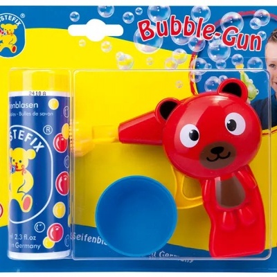 Conjunto Bubble-Gun com pistola urso vermelho, tubo solução bolhas azul e copo azul em embalagem colorida.