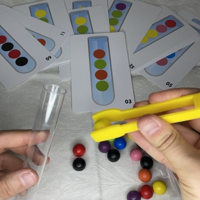 Jogo de cartas e bolas coloridas com tubo de ensaio e pinça amarela