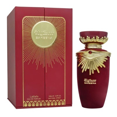 Frasco de perfume vermelho e dourado com caixa correspondente